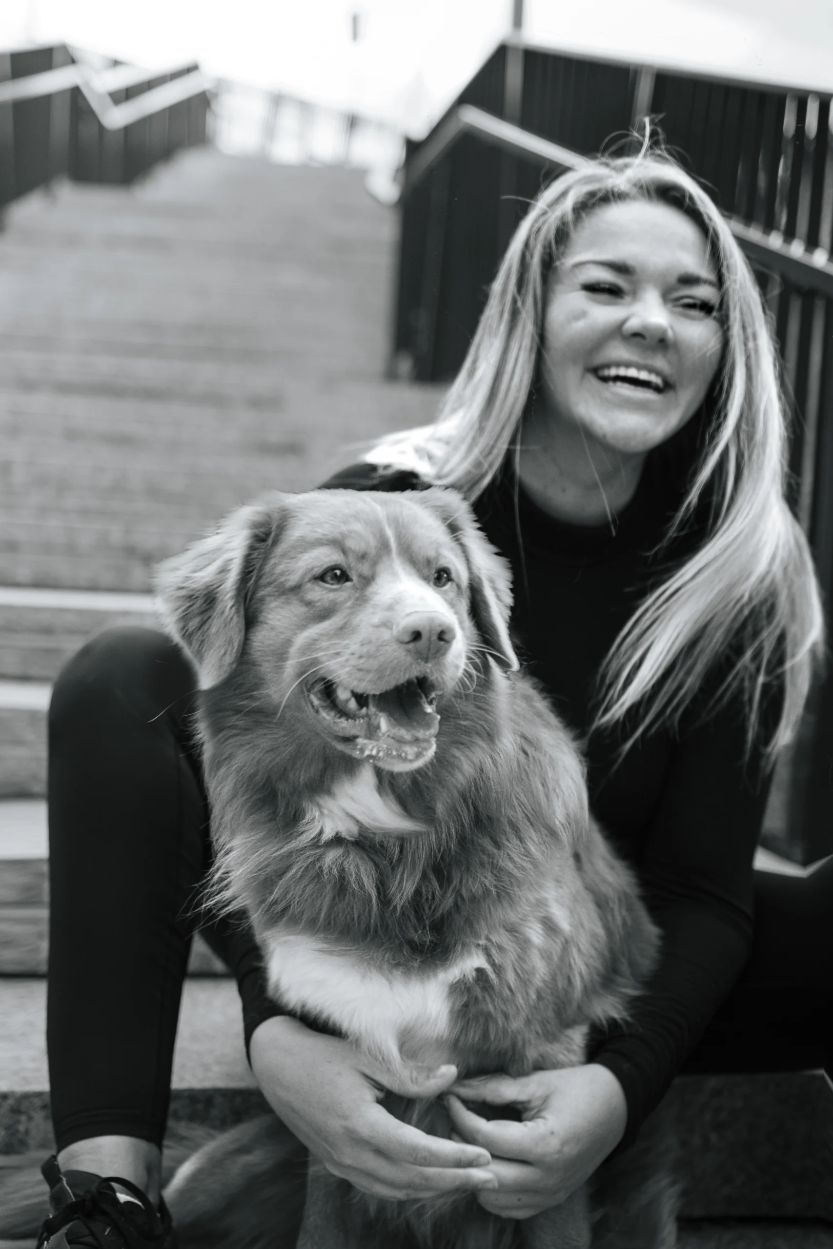 Brux raw dog food founder Paula Kink posing with her Nova Scotia Duck Tolling Retriever Bruno